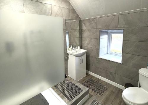 ein Badezimmer mit Toilette und Waschbecken in der Unterkunft Smiddy Cottage in Portmahomack