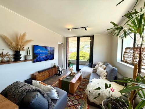 a living room with a couch and a table at Mossel Bali - Mossel Cove in Mossel Bay