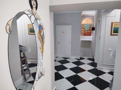 a room with a mirror and a checkered floor at Le Nouveau Grand Tour - Dimora del Commendatore in San Giorgio Morgeto