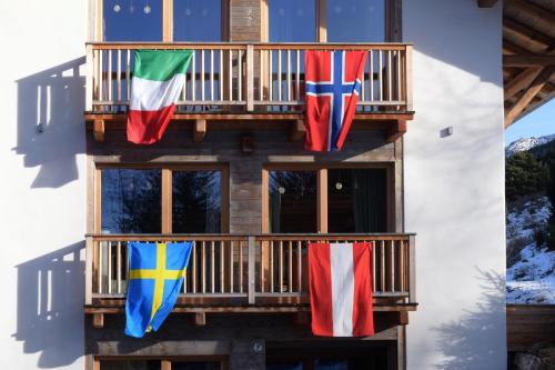 a group of flags hanging on a balcony at B&B Mas de Lagorae in Tesero