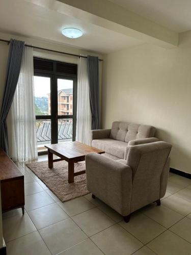a living room with a couch and a coffee table at Elegant and Modern Homes, 2BR unit in a secure estate near the golf course in Mbarara