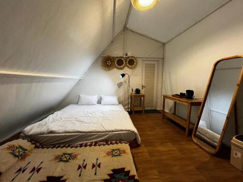 a bedroom with a bed in a tent at D'River Luxcamp 
