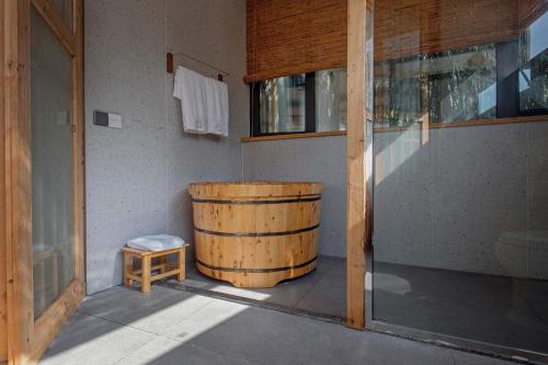 a large wooden barrel sitting next to a door at Shan Jue Xing She in Nan'an