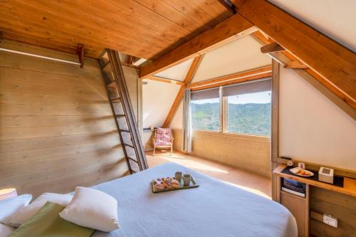 a bedroom in a tree house with a large bed at Il Castagno Toscana Glamping in Campiglia Marittima
