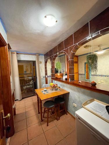 a kitchen with a wooden table and a dining room at Apartamentos San Jose in Valle Gran Rey