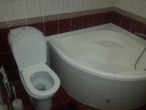a small bathroom with a toilet and a sink at Islambek Hotel & Travel in Khiva