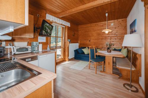 a kitchen and living room with a table and a couch at Kleintierhof Seidl-Eder in Rauris