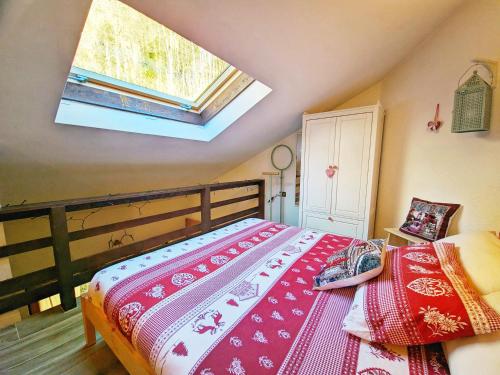 a bedroom with a bed and a skylight at ALLA CASCATA in centro Branzi self check-in parcheggio gratuito coperto in Branzi