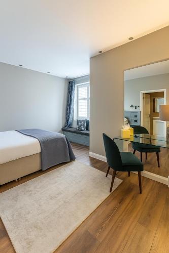 a bedroom with a bed and a glass table at Onyx House in Blackpool