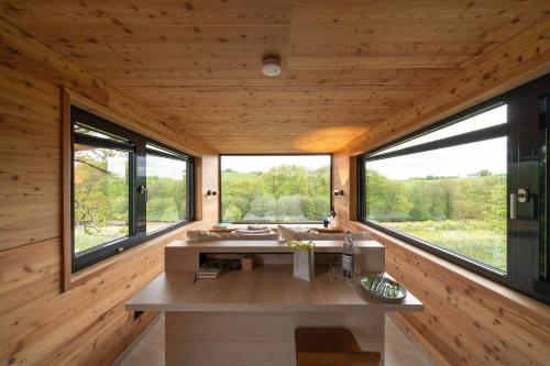 a bathroom in a log cabin with windows at Oak - K1 Baumhaus in Odenthal