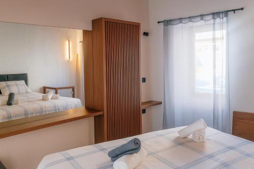 a hotel room with two beds and a window at Evanthia maisonette in Chalkida