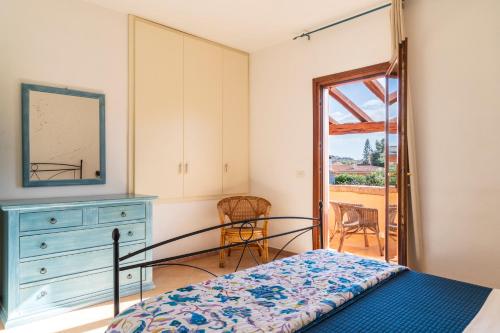 a bedroom with a bed and a dresser and a mirror at Vecchio Stazzo in San Teodoro
