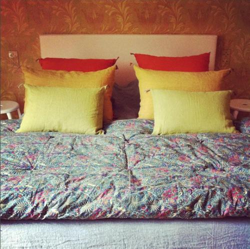 
a bed with two pillows on top of it at Maison Flagey Brussels in Brussels
