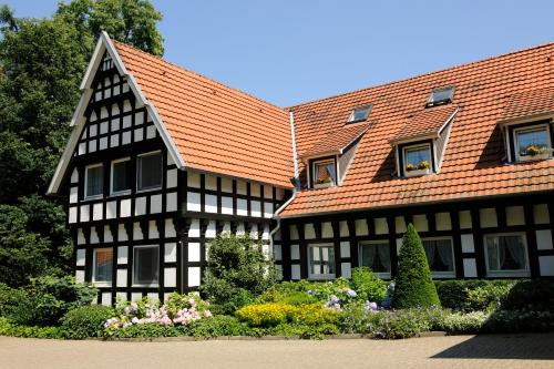 a black and white building with an orange roof at VILA VITA Burghotel Dinklage in Dinklage