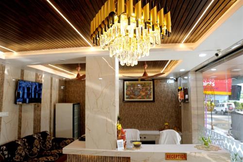 a chandelier hangs from the ceiling of a restaurant at GM hotel in Tirupati