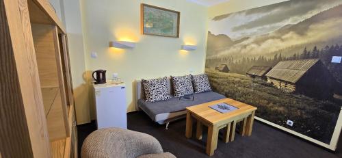 a living room with a couch and a table at Pensjonat Jastrzębia Turnia in Zakopane