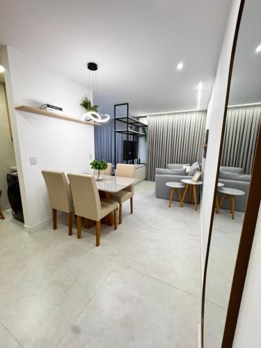 a living room with a table and chairs at Studio Premium Batista Campos in Belém