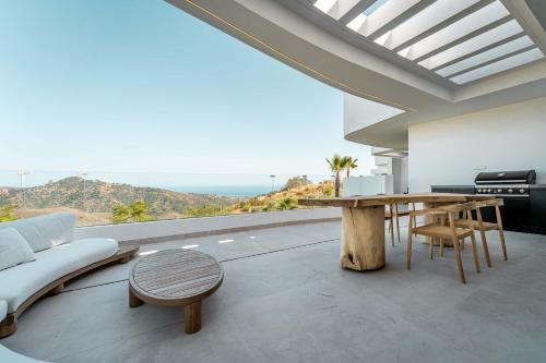 a living room with a table and a view of the ocean at Palo Alto 9 Panoramic Views Terrace Luxury in Monda