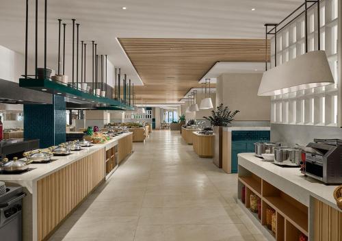 a large kitchen with tables and counters in a restaurant at Akra Antalya in Antalya