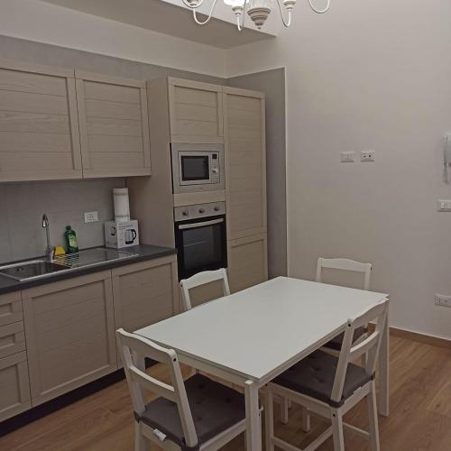 a kitchen with a white table and chairs in it at Ionian Breeze in Taranto