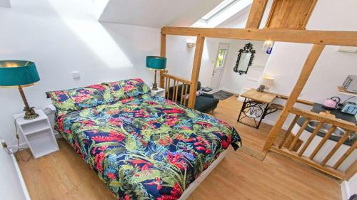 a living room with a bed and a table at Bag-End House - Unique home with Balcony, Beautiful Views, Ping Pong and Hot Tub option - Sleeps 14 in Croyde