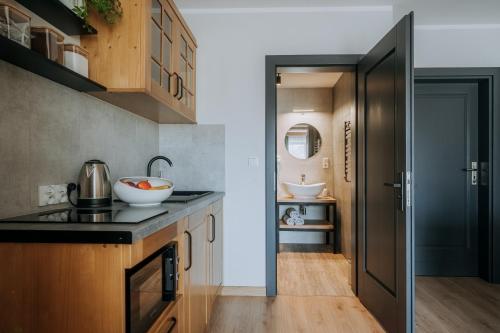 a kitchen with a sink and a counter top at Willa Janowa & SPA in Bukowina Tatrzańska