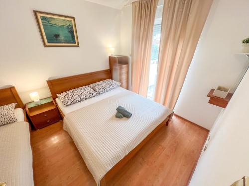 a bedroom with a bed with a bag on it at Apartment Pali in Klek