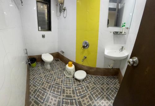 a bathroom with a sink and a toilet and a sink at Hotel Sunshine Airport in Mumbai