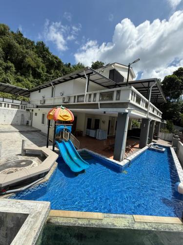 a house with a pool and a slide at 25PAX 5BR Villa Kids Swimming pool, KTV, BBQ near SPICE Arena Penang 9800 SQFT in Bayan Lepas