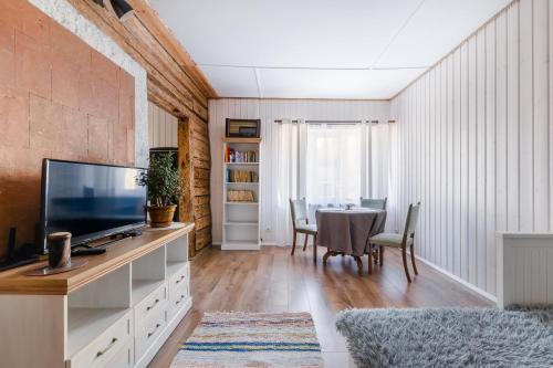 a living room with a table and a television at Rakvere Old Town Home in Rakvere