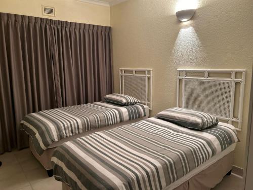 two beds sitting next to each other in a room at Eden Wilds 42 in Port Edward