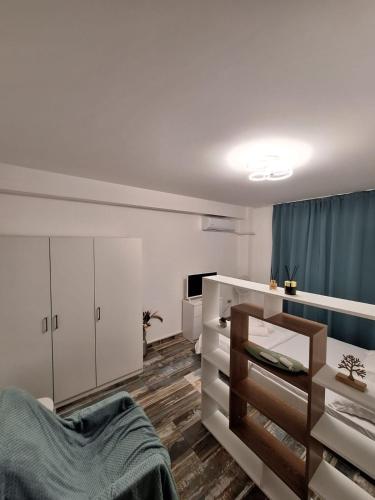 a bedroom with white cabinets and a bed in it at Petit Blue in Dudu