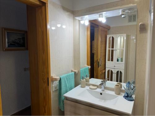 a bathroom with a sink and a mirror at House with balcony and views of the Atlantic in El Pris in El Pris