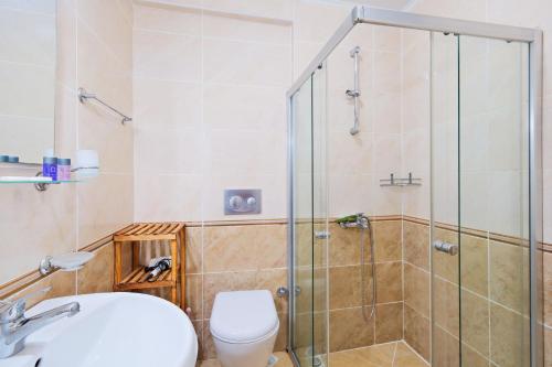 a bathroom with a shower and a toilet and a sink at Legend Apartments II Fethiye in Fethiye