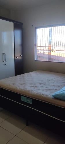 a large bed in a room with a window at Casa Refúgio in Ibicoara