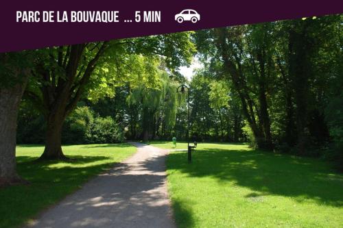 a path in a park with trees and grass at Le Chant des Oiseaux-Campagne-SPA-Parking in Abbeville