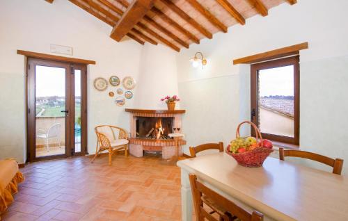 a living room with a fireplace and a table at Pet Friendly Home In Acquasparta in Quadrelli