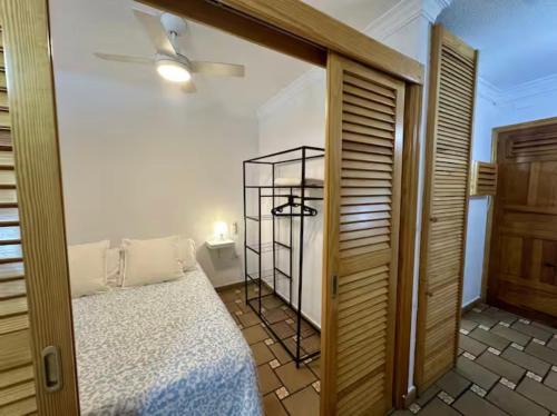 a bedroom with a bed and a ceiling fan at House with balcony and views of the Atlantic in El Pris in El Pris