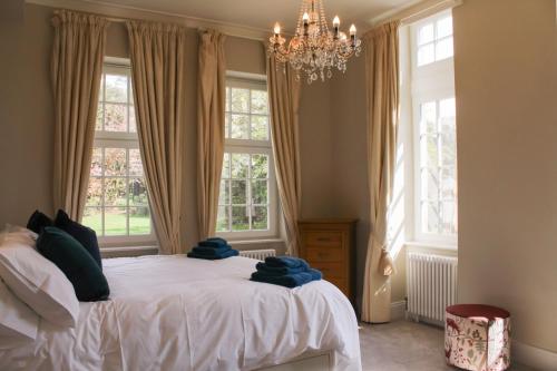 a bedroom with a bed with blue towels on it at The Dower House at Solsgirth Home Farm in Dollar