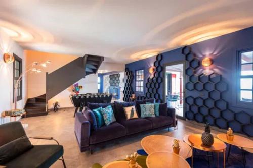 a living room with a couch and tables at Sun-Soaked Haven With Caribbean Views in Gustavia