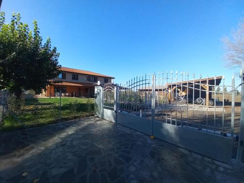 a gate with a fence in front of a building at Room & Breakfast Olmo Tondo in San Giovanni in Persiceto