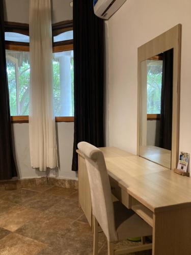 a dining room with a table and a mirror at pasha nungwi zanzibar in Nungwi