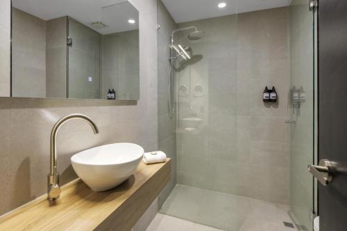 a bathroom with a sink and a shower at Park Inn by Radisson Melbourne Carlton in Melbourne