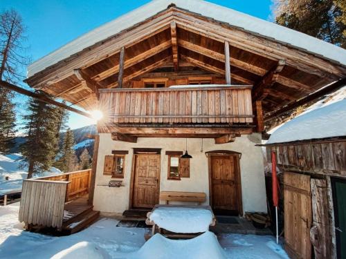 a cabin with a balcony in the snow at Turracher Hütte in Turracher Hohe