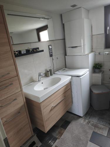 a small bathroom with a sink and a toilet at Haus Kerkyra in Dickesbach
