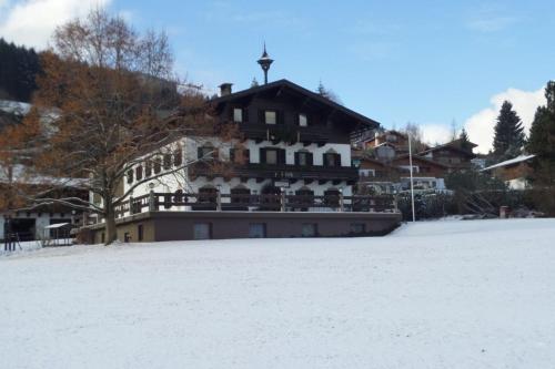 a large building in the snow with snow at Hinterauhof in Rain
