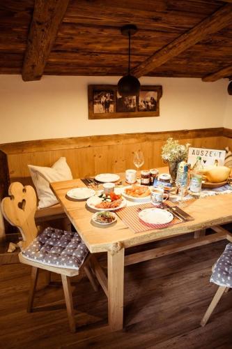 a wooden table with plates of food on it at Tröglesalm in Matrei in Osttirol