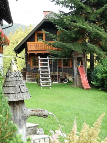 a house with a playground in front of it at Jägerkeusche in Unterpreitenegg