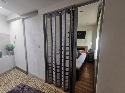 a room with a door to a bedroom with a bed at Ferienhaus Congolo in Lontzen