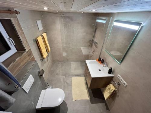 a bathroom with a toilet and a sink and a shower at Chalet Luxeck in Steinberg am Rofan